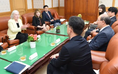 A group of people meeting in a boardroom