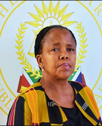 African woman in front of official emblem background