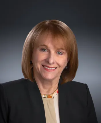 Professional headshot of a middle-aged woman smiling