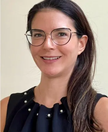 Smiling woman with glasses wearing black top