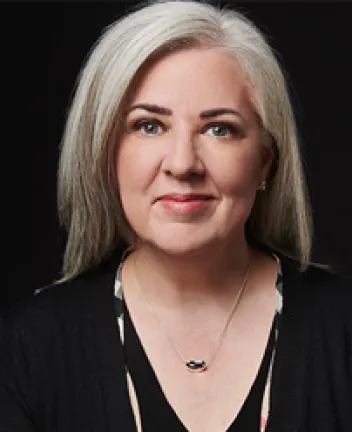 Professional headshot of woman with gray hair